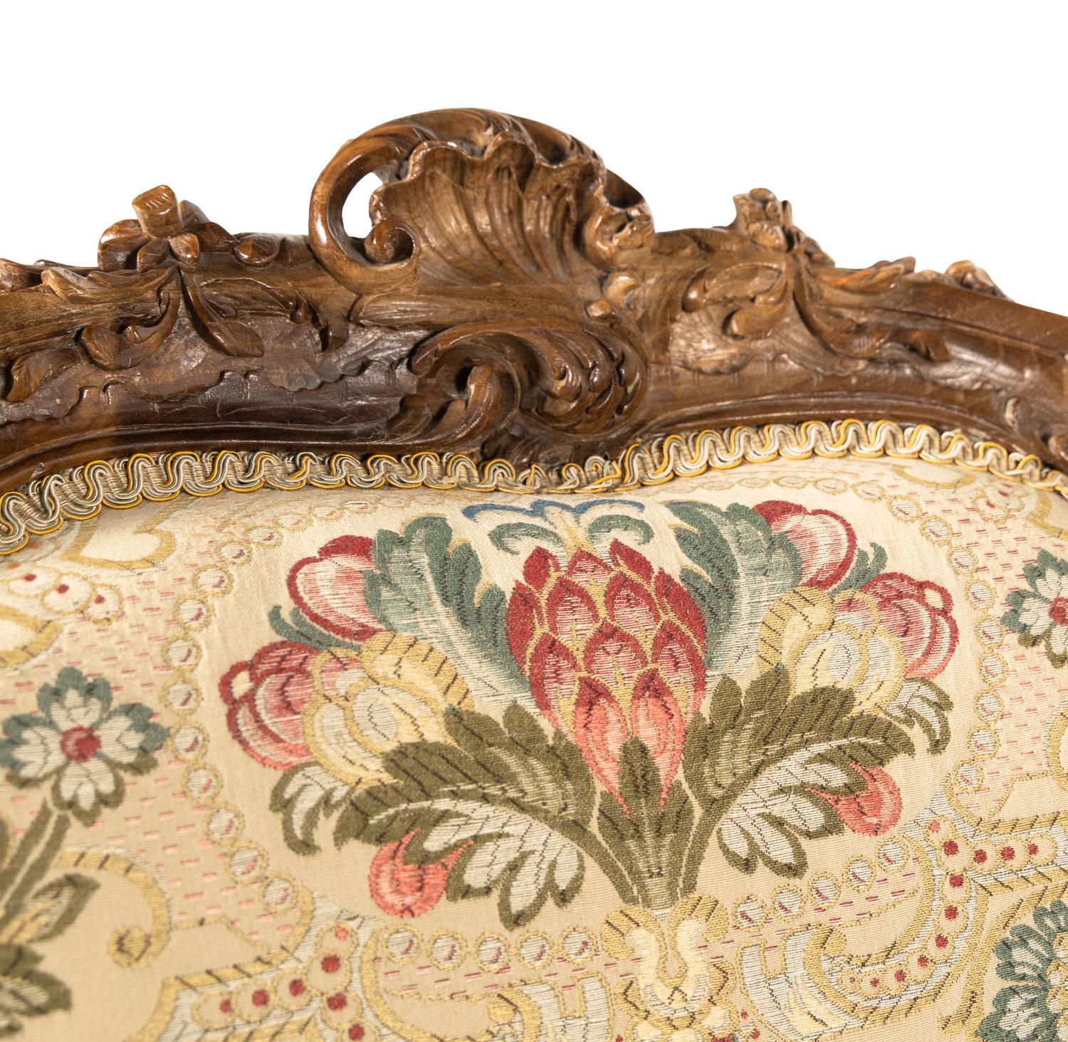 A Pair of Louis XV Style Carved Walnut Bergères
