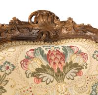 A Pair of Louis XV Style Carved Walnut Bergères