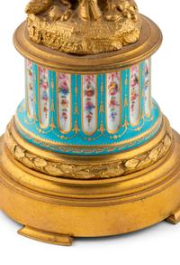 A Pair of French Gilt Bronze and Bourdin Porcelain Figural Candlesticks