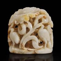 A Chinese reticulated white and russet jade finial 透雕玉炉端