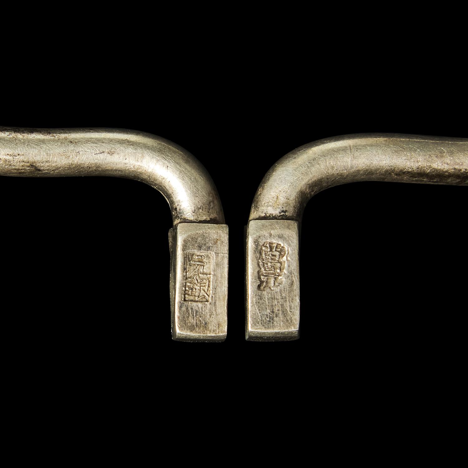 A Chinese Silver Necklace and Eight Chinese Silver Ruyi Lock-Form Pendants, Qing Dynasty 清 銀項圈一及銀如意頭形長命鎖一組八件