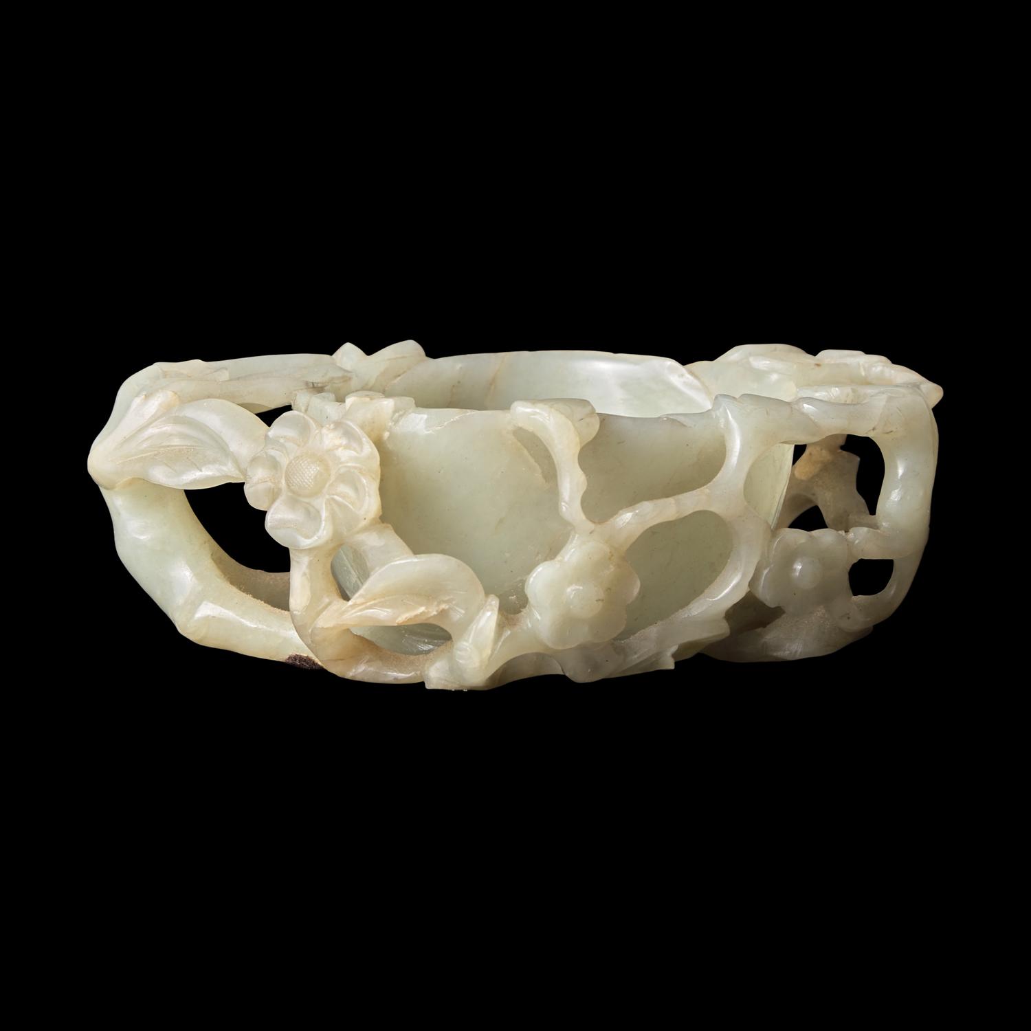 A Chinese Carved Pale Celadon Jade Floriform Coupe, Qing Dynasty or Earlier 清或更早 青白玉鏤雕梅花洗