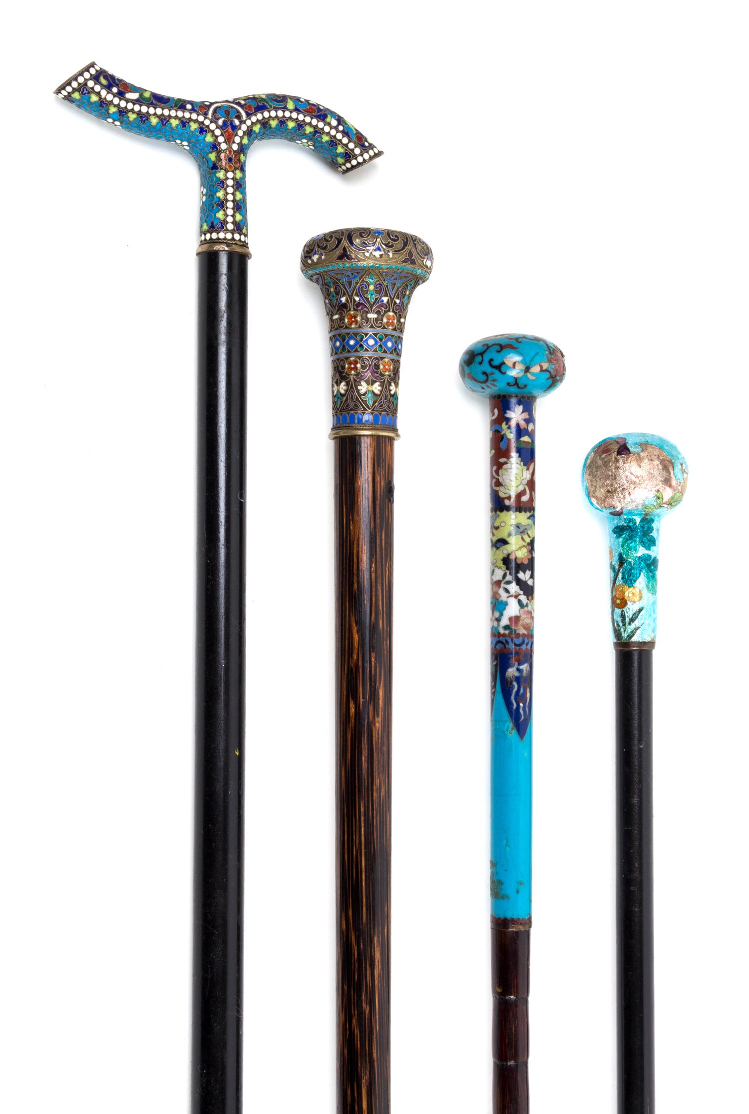 Four Enameled Metal Mounted Walking Sticks Length of longest 38 3/4 inches.