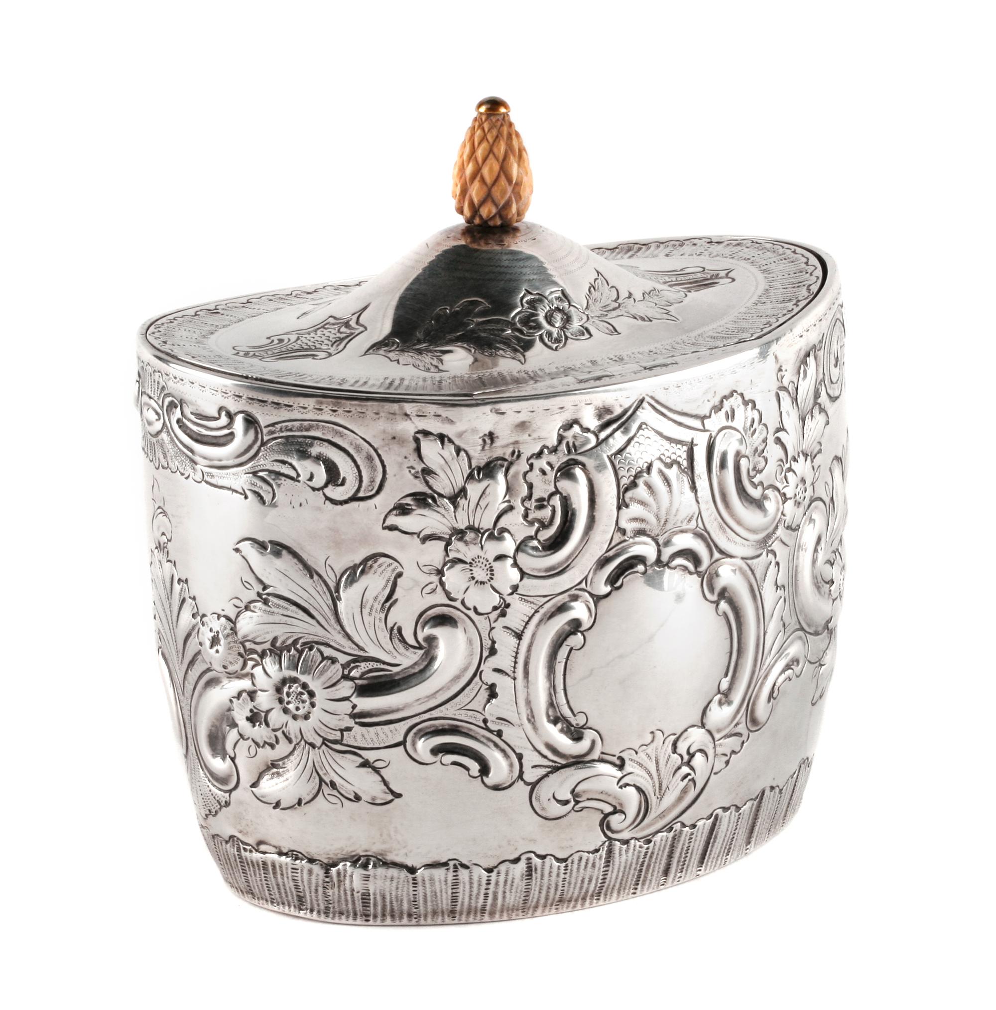 An English Silver Tea Caddy, John Schofield, London, 1794, the oval domed lid with a pinecone finial, the body bearing a vacant cartouc