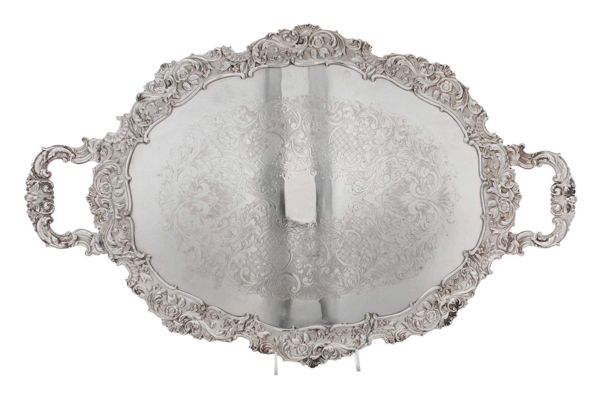 Two English Silver-Plate Trays, 20th Century, comprising an oval handled tray and a circular tray, each after the 18th century original