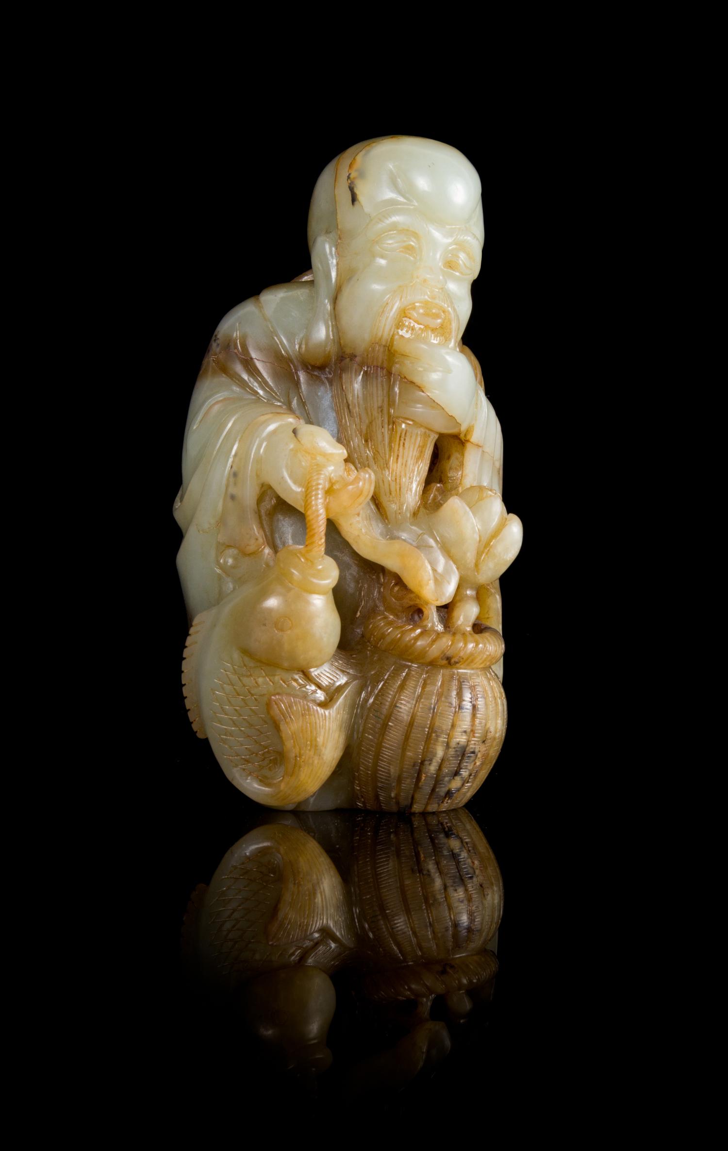 A Celadon and Brown Jade Figure of the Immortal of Longevity, Shoulao Height 5 1/8 inches.