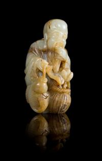 A Celadon and Brown Jade Figure of the Immortal of Longevity, Shoulao Height 5 1/8 inches.