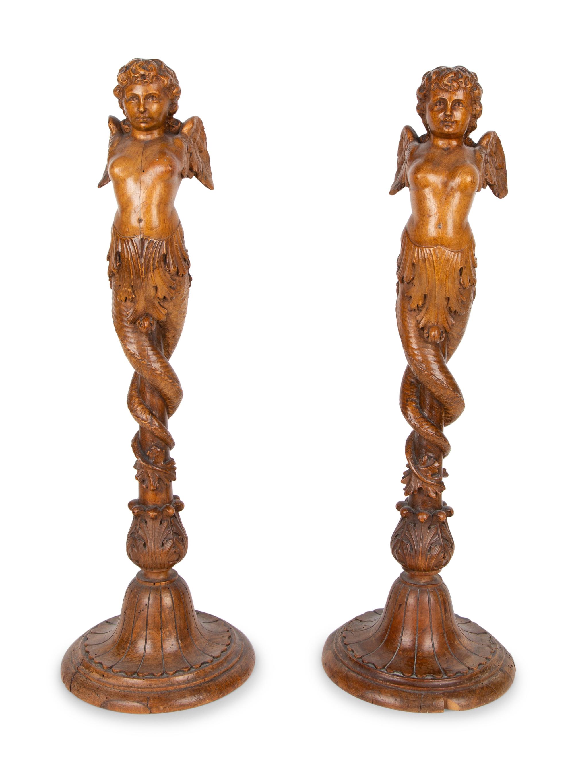A Pair of Italian Carved Walnut Putti on Fluted Bases — 18TH/19TH CENTURY