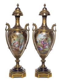 A Pair of Sevres Gilt Bronze Mounted Porcelain Urns Height 29 inches.