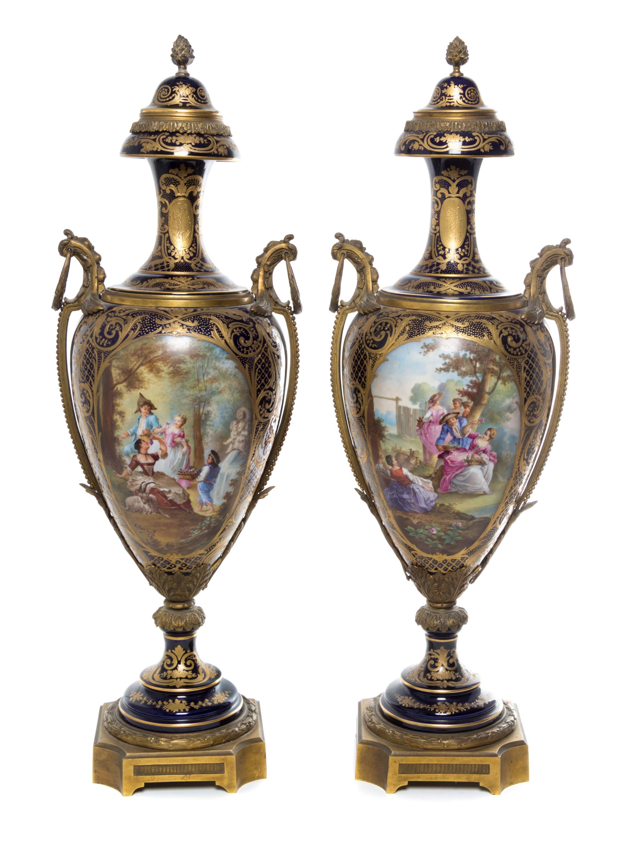 A Pair of Sevres Gilt Bronze Mounted Porcelain Urns Height 29 inches.