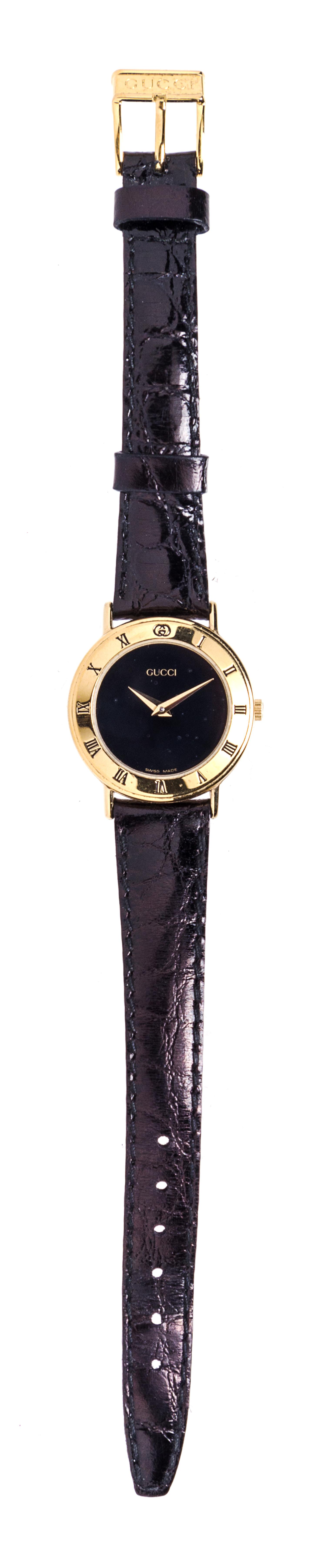 A Gucci Goldtone Wristwatch, 7" x 1".