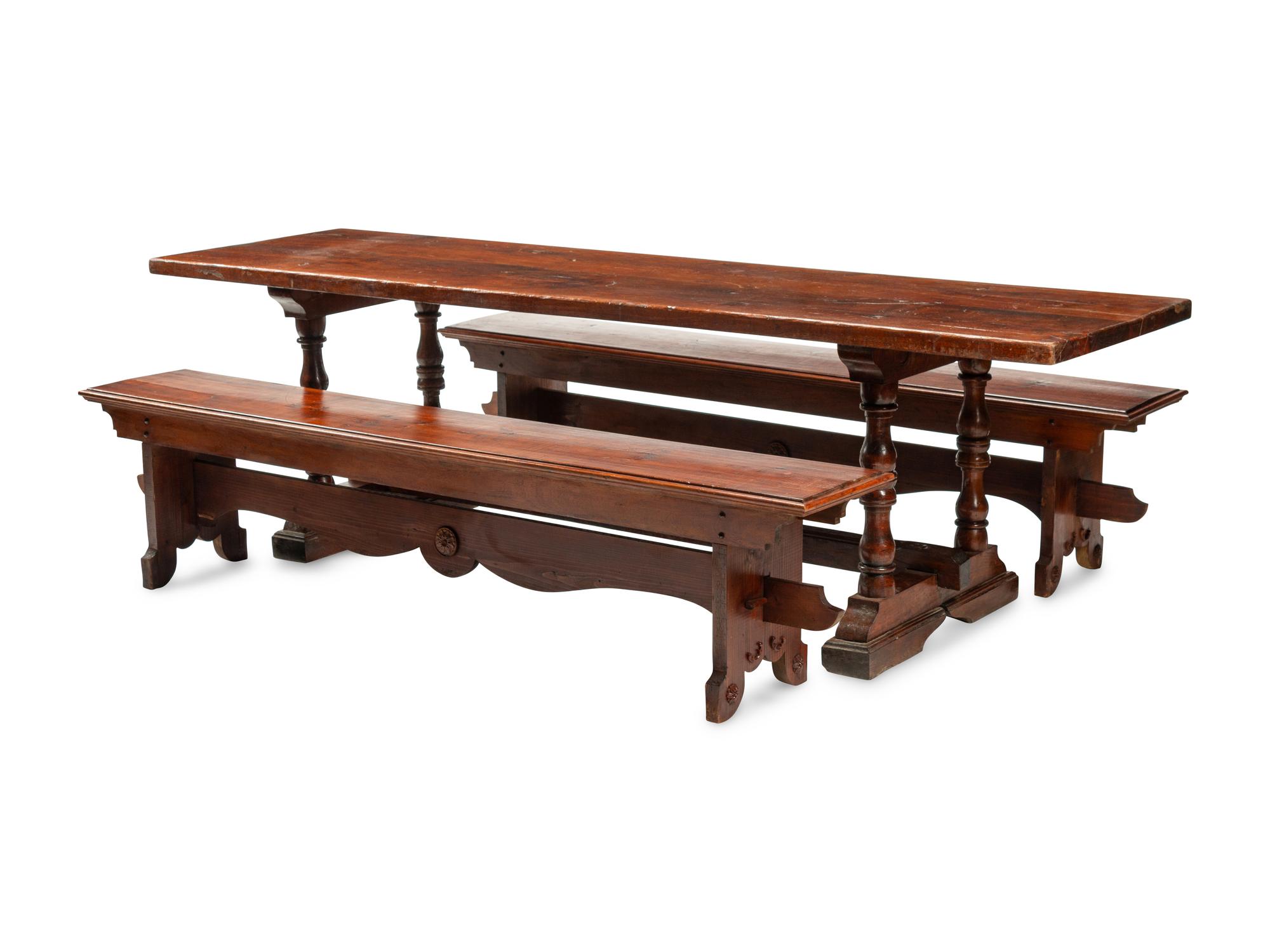 An English Baroque Style Walnut Trestle Table and a Pair of Associated Benches