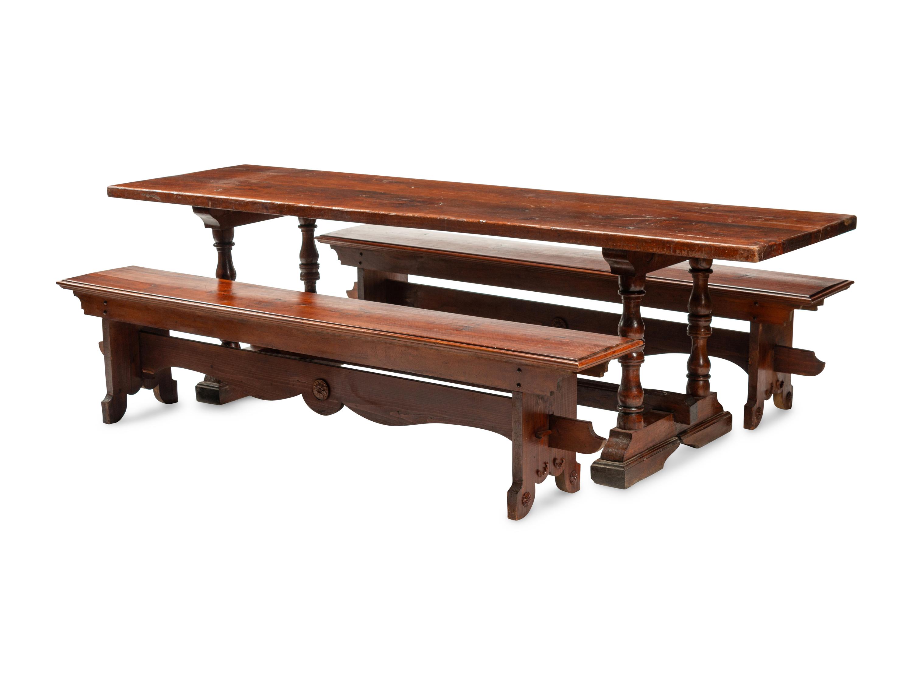 An English Baroque Style Walnut Trestle Table and a Pair of Associated Benches