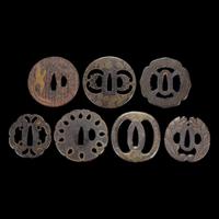 Group of seven Japanese inlaid iron tsuba Edo period or earlier
