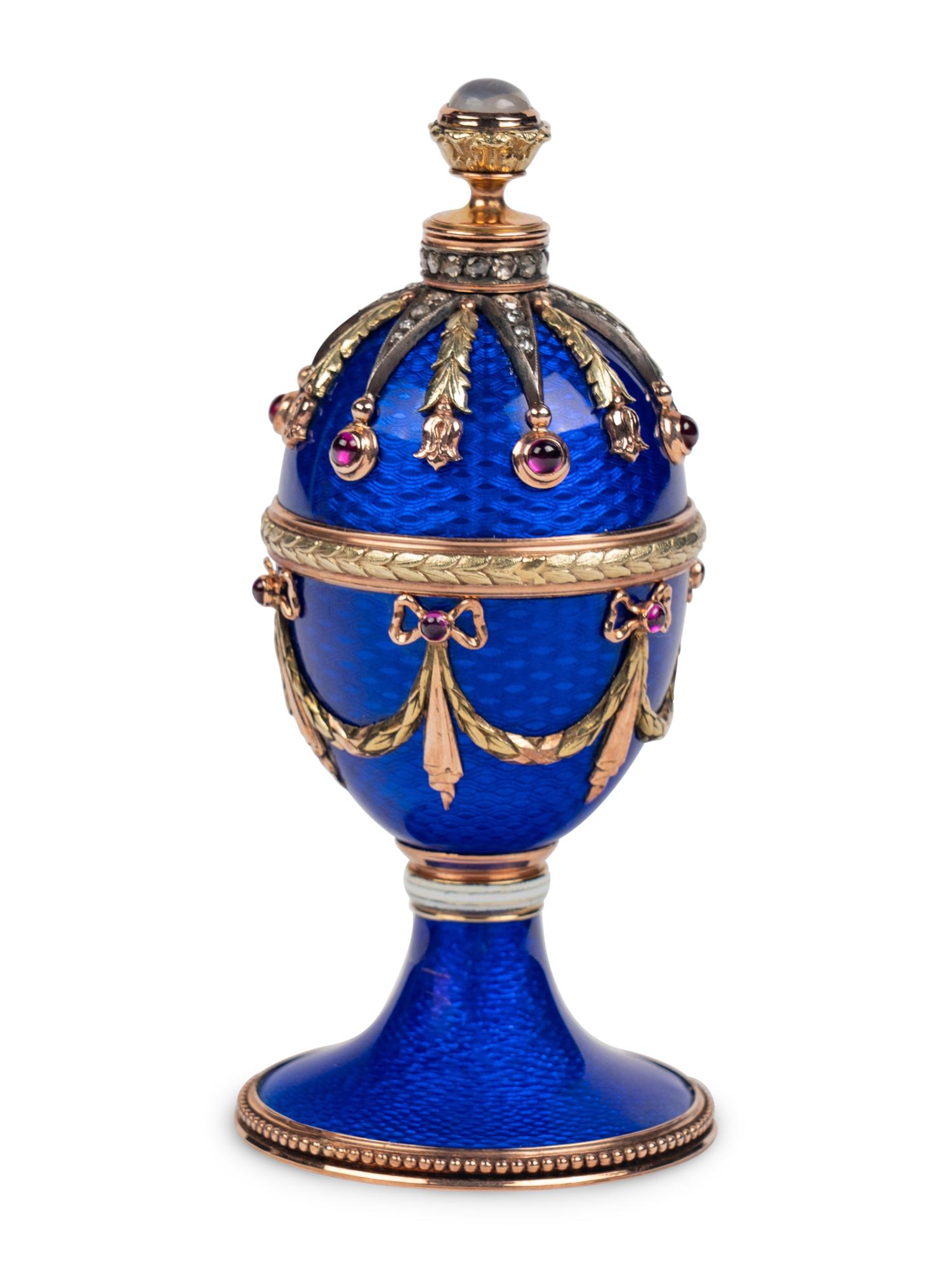 A 14 Karat Vari-Color Gold, Guilloché Enamel, Diamond, and Cabochon Jewel-Mounted Egg-Form Perfume and a Related Guilloché Enamel, 14 Karat Vari-Color Gold, Diamond, and Cabochon-Mounted Surprise Egg
