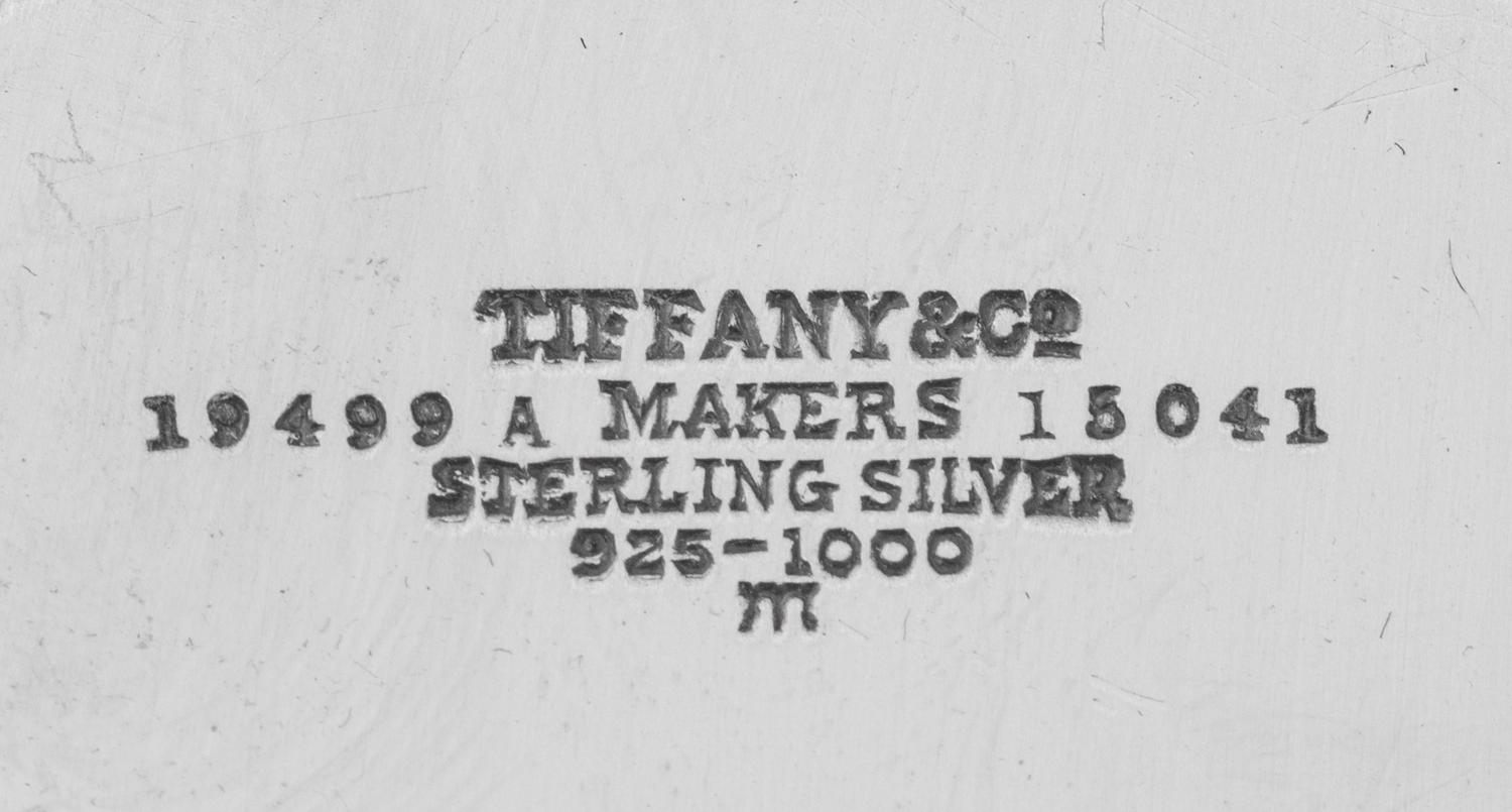 A Tiffany and Co. Silver-Mounted Twelve-Piece Dresser Set