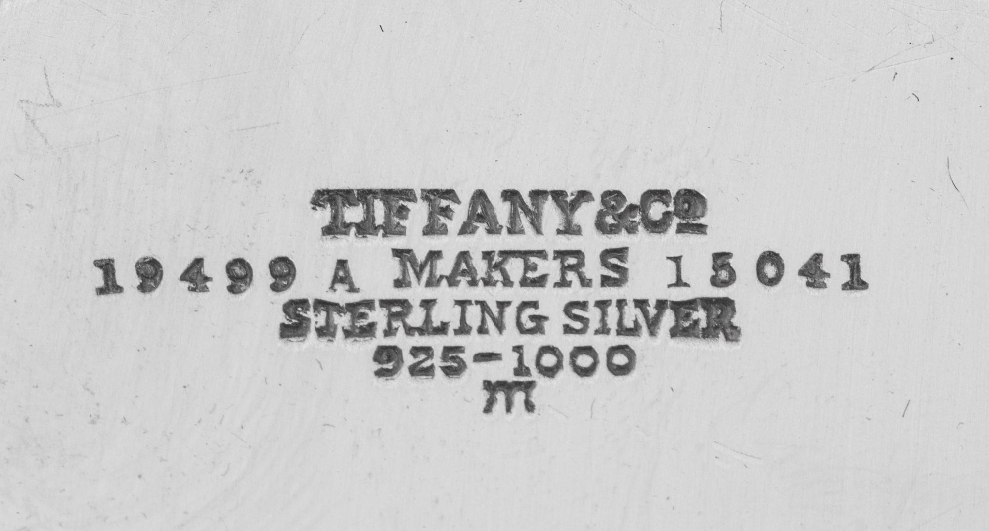 A Tiffany and Co. Silver-Mounted Twelve-Piece Dresser Set