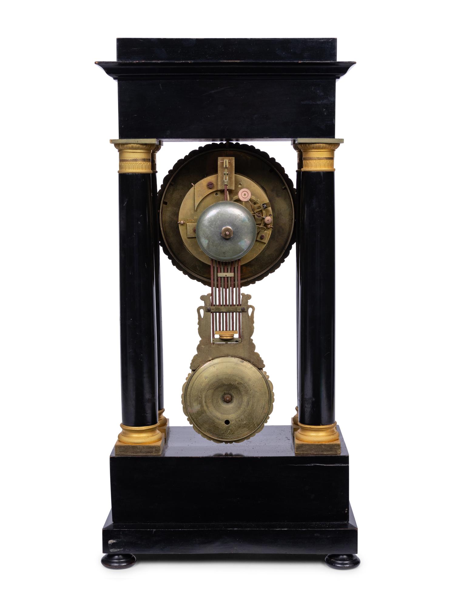 A Charles X Gilt Bronze Mounted Ebonized Portico Clock