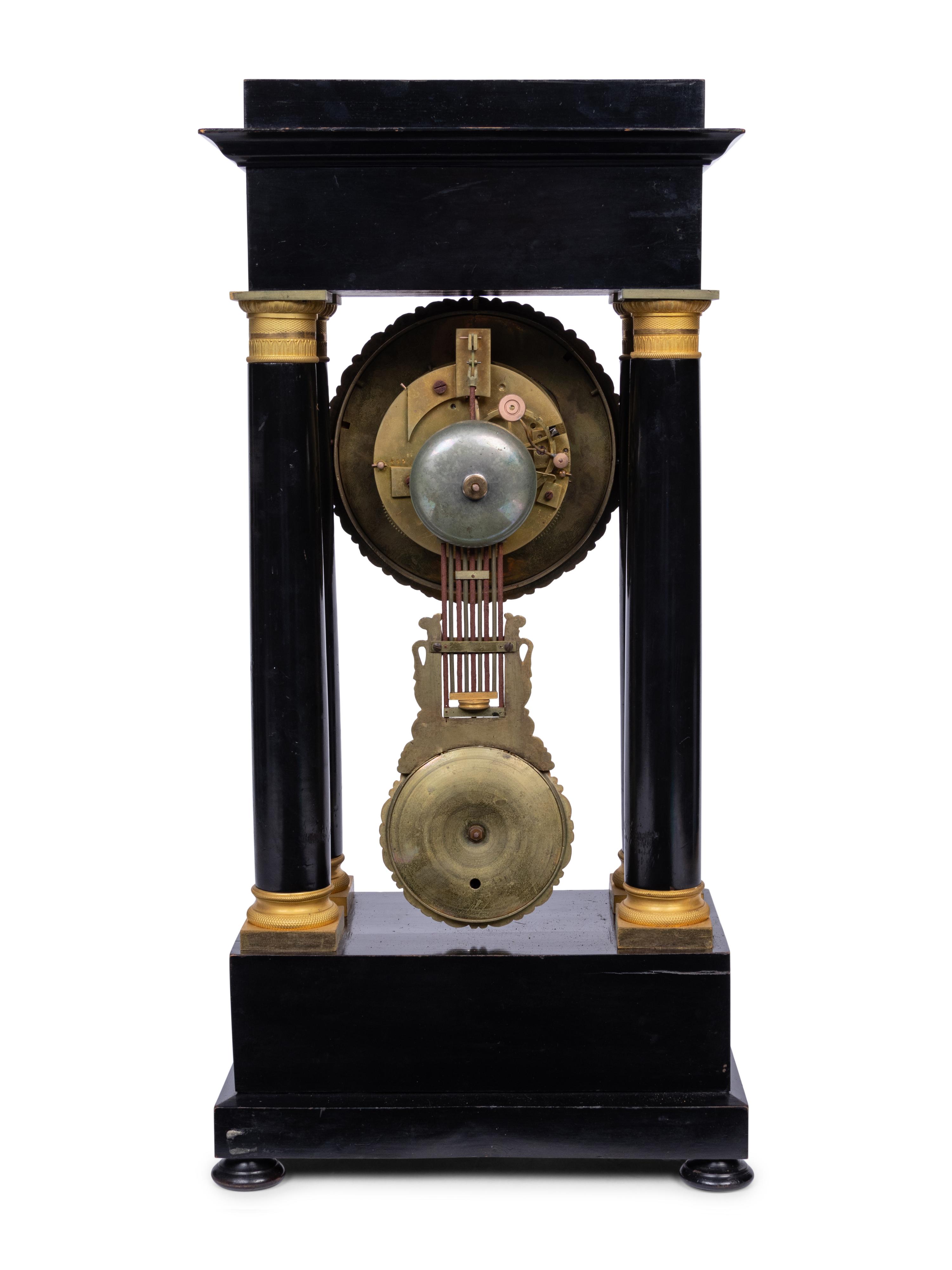 A Charles X Gilt Bronze Mounted Ebonized Portico Clock