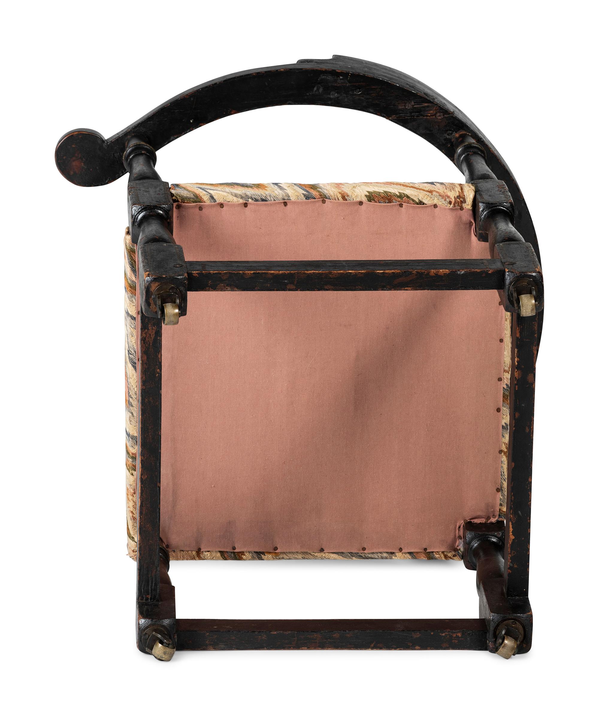 A William and Mary Black Painted and Parcel Gilt Roundabout Corner Chair