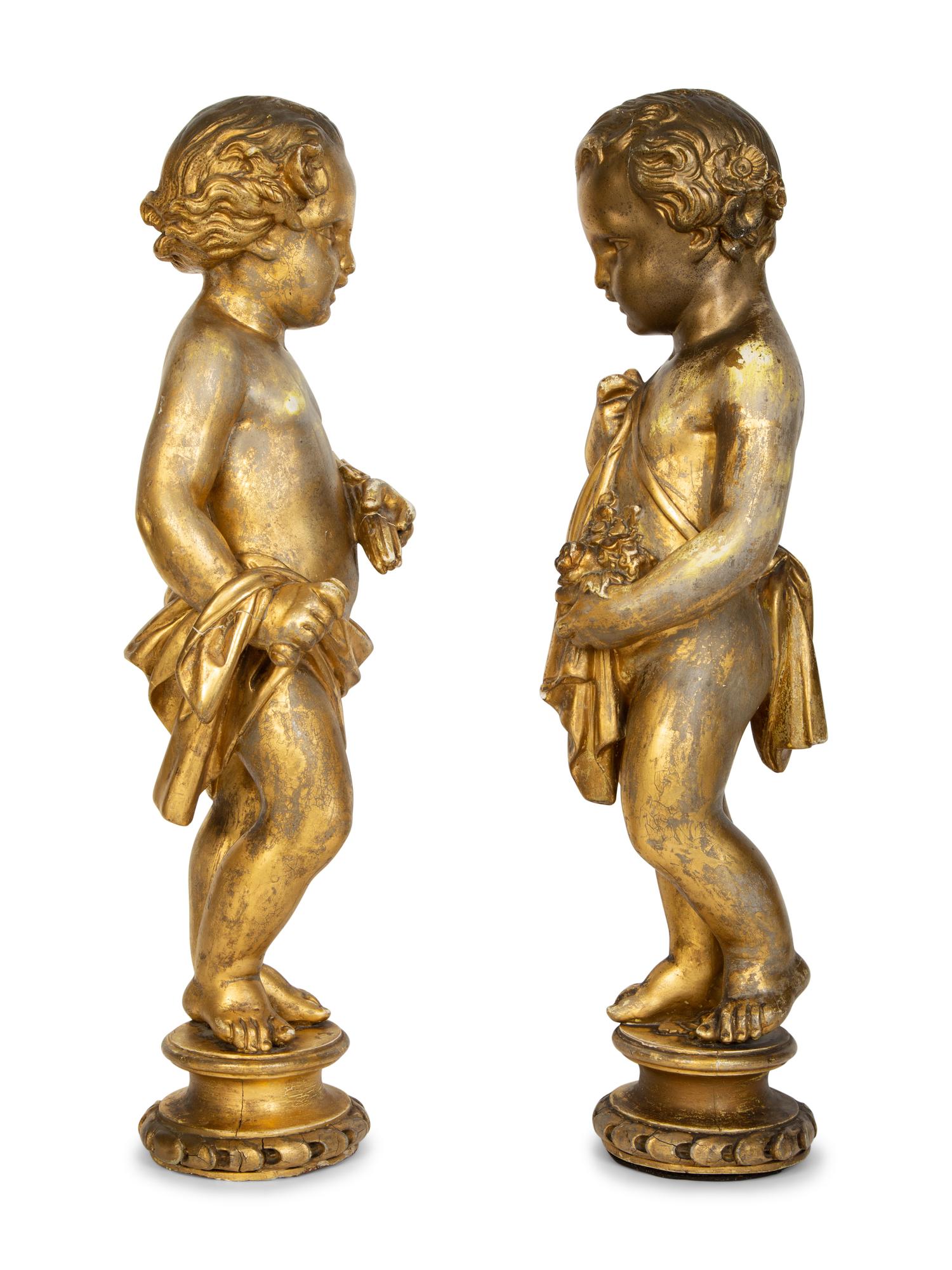 A Pair of Continental Giltwood Figures of Putti