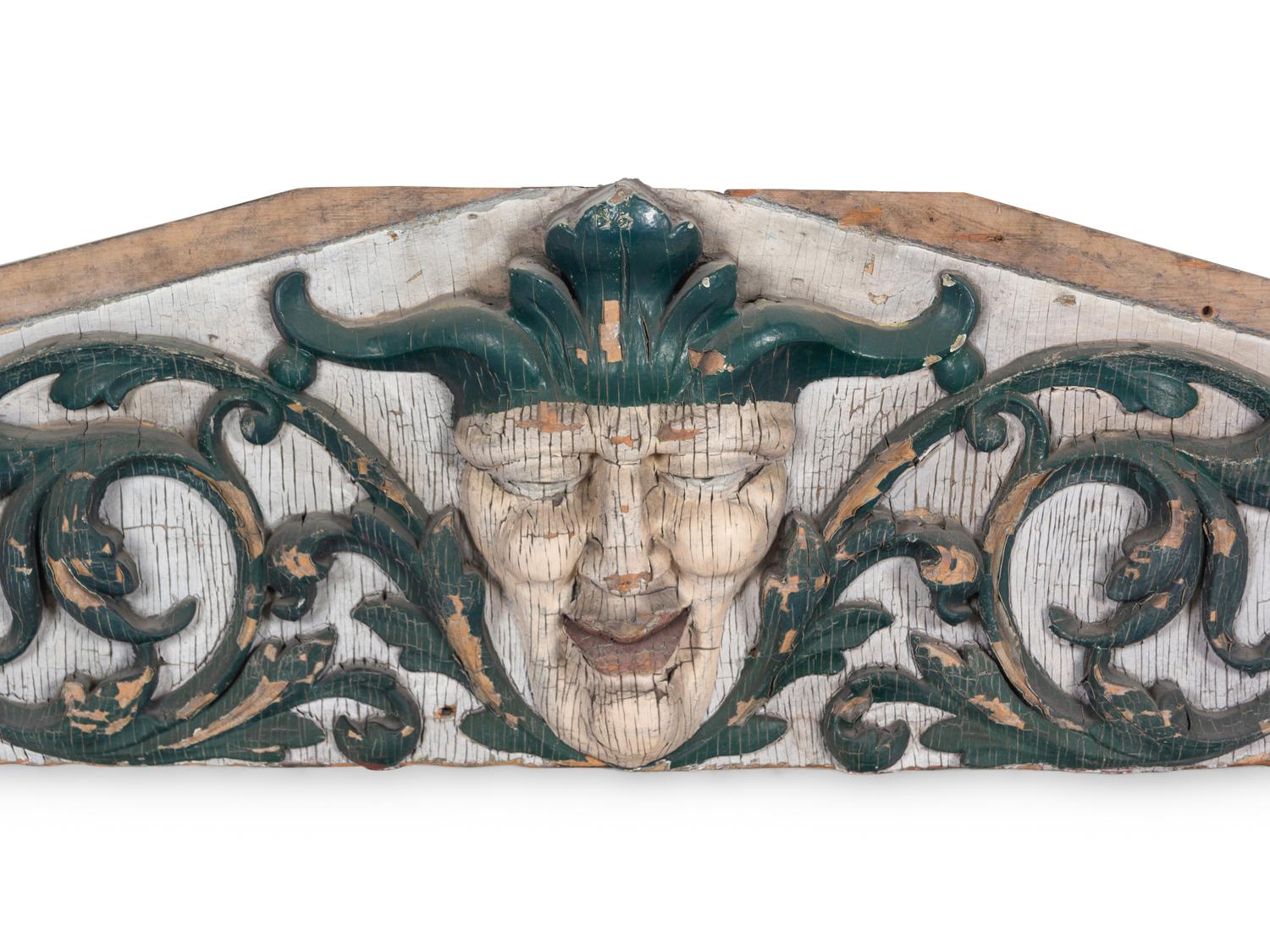 A Carved and Painted Pine Pediment Panel