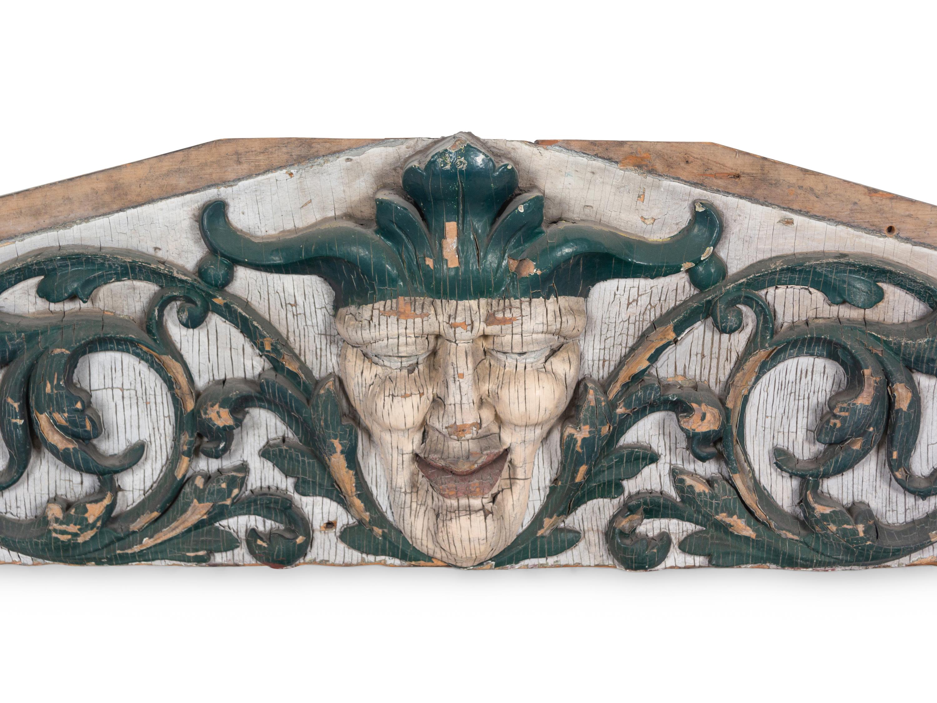 A Carved and Painted Pine Pediment Panel