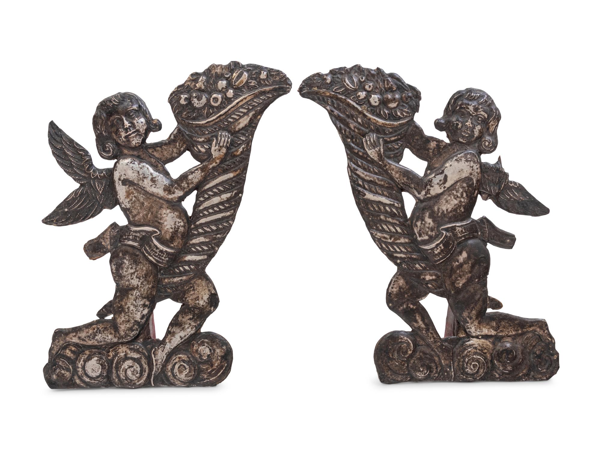A Pair of Silver Clad Figures of Angels