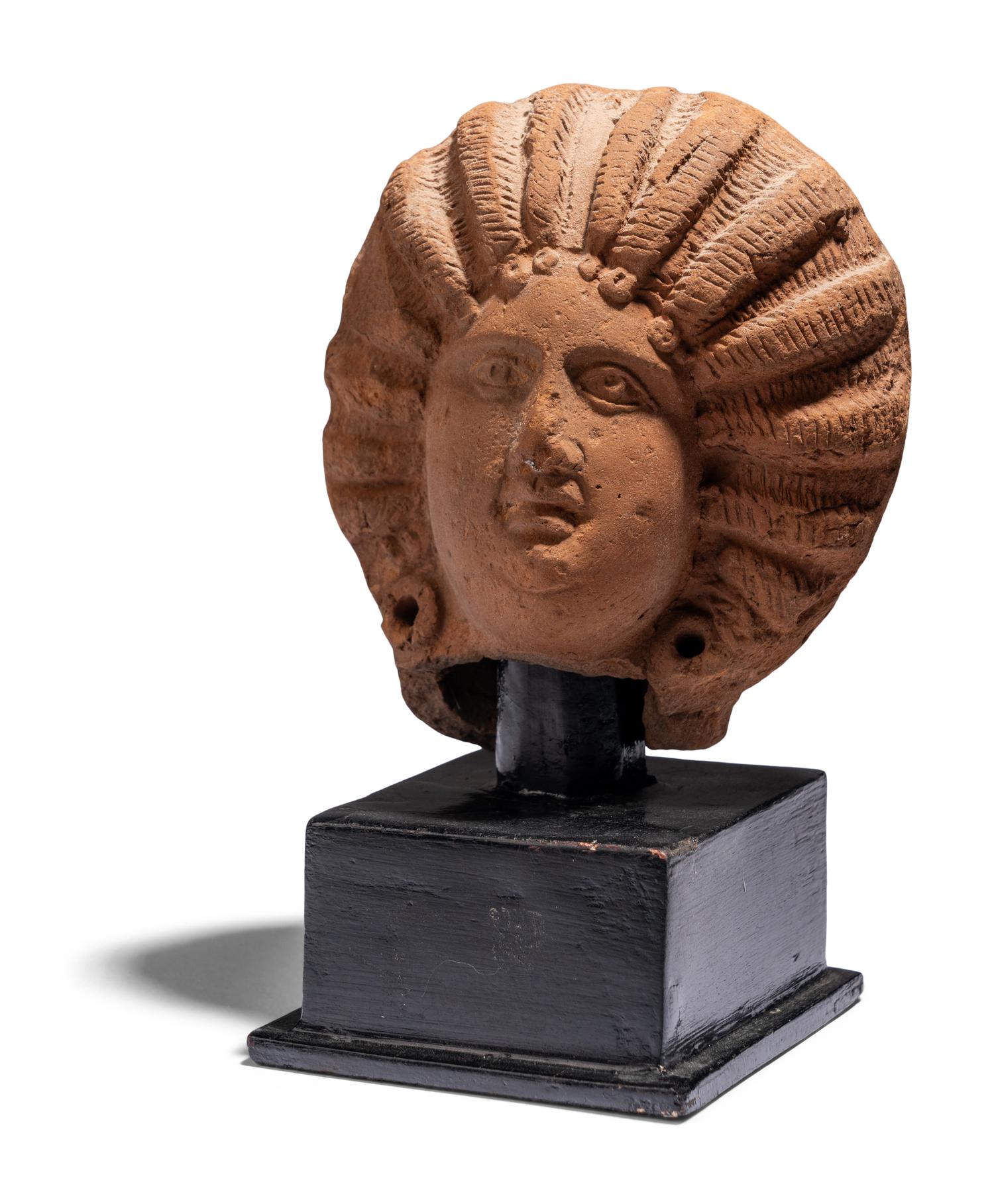 A Roman Terracotta Head of a Female with Melon Coiffure