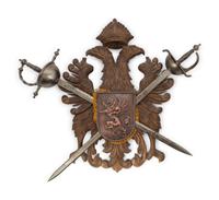 A Continental Carved Armor Trophy with Crossed Swords