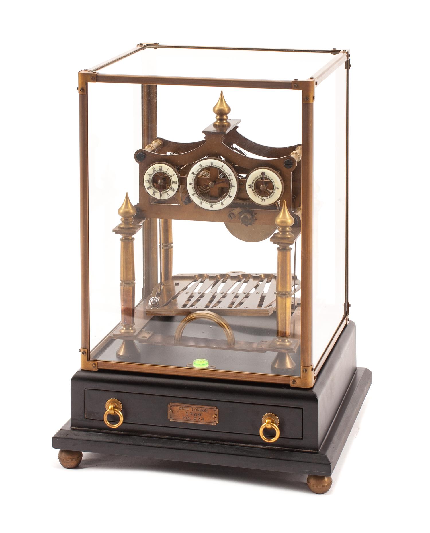 A Patinated Bronze Congreve Mantel Clock Height 15 1/2 x width 11 x depth 10 1/2 inches.