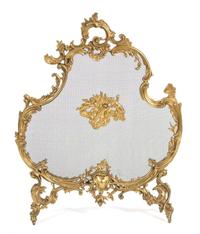 A Louis XV Style Gilt Bronze and Wire Mesh Cartouche-Form Fire Screen Height 33 3/4 x width 26 1/2 inches. — 19TH CENTURY