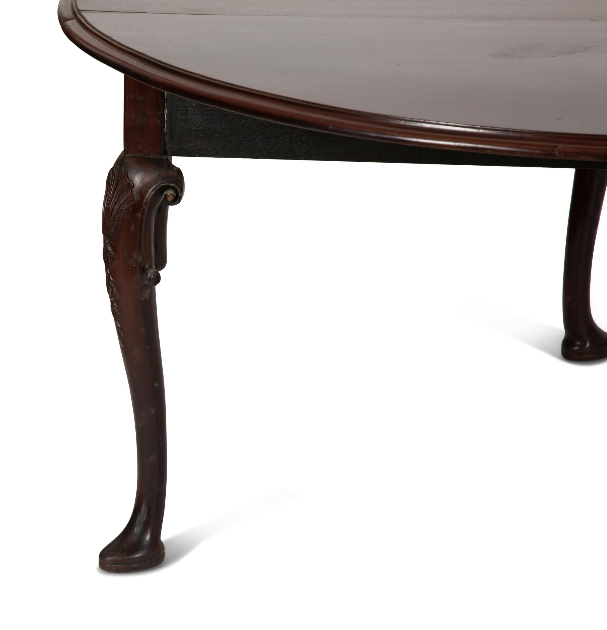 An Irish George II Style Carved Mahogany Drop Leaf Dining Table
