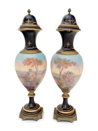 A Pair of Sèvres Style Gilt Bronze Mounted Porcelain Urns