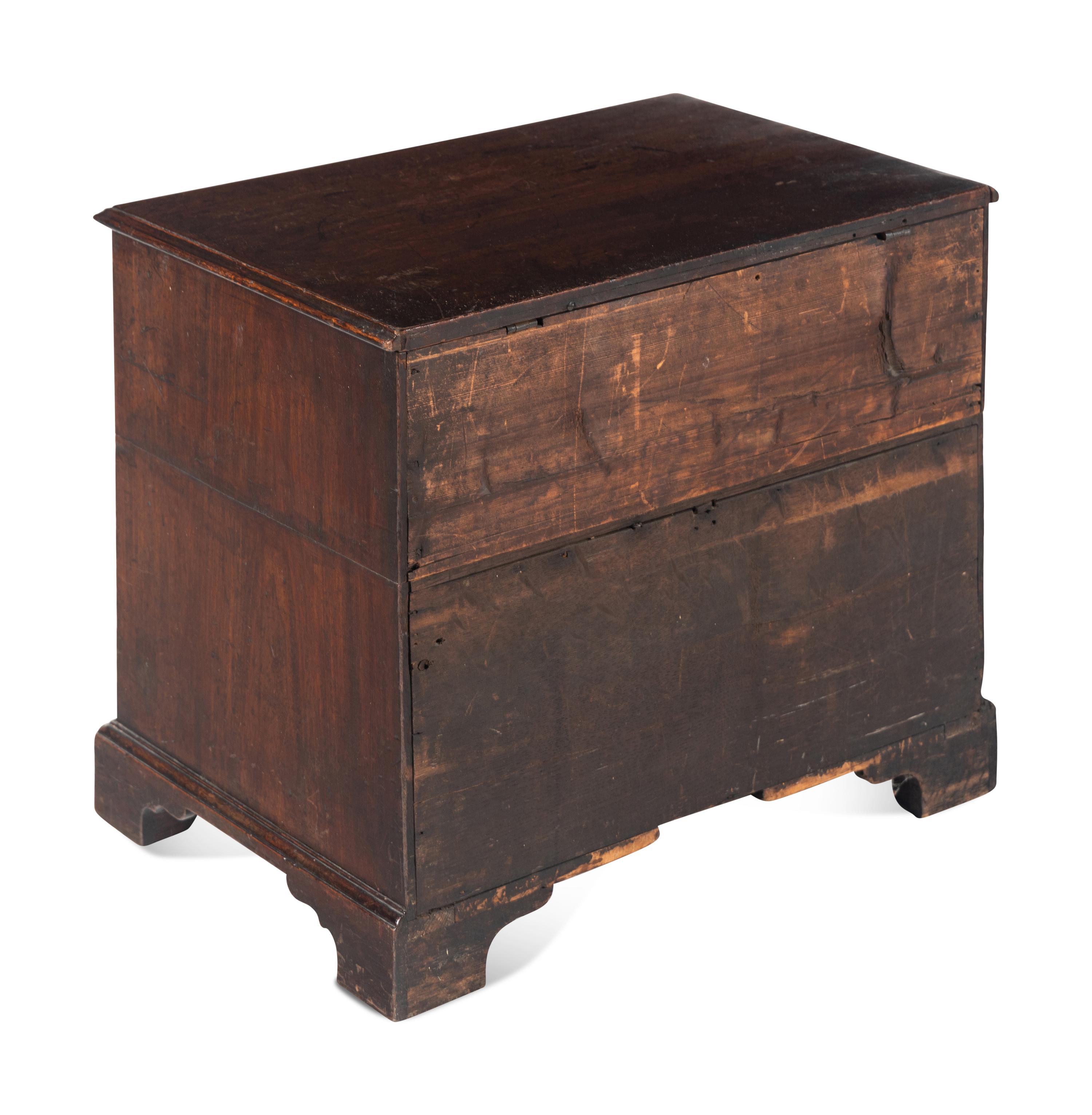 A George III Diminutive Lift-Top Chest of Drawers