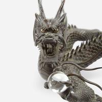 A Japanese patinated bronze dragon and rock crystal sphere Meiji period