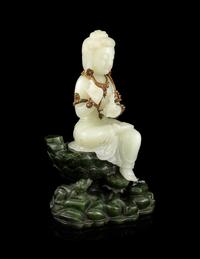 A Pale Celadon and Spinach Jade Figure of Guanyin