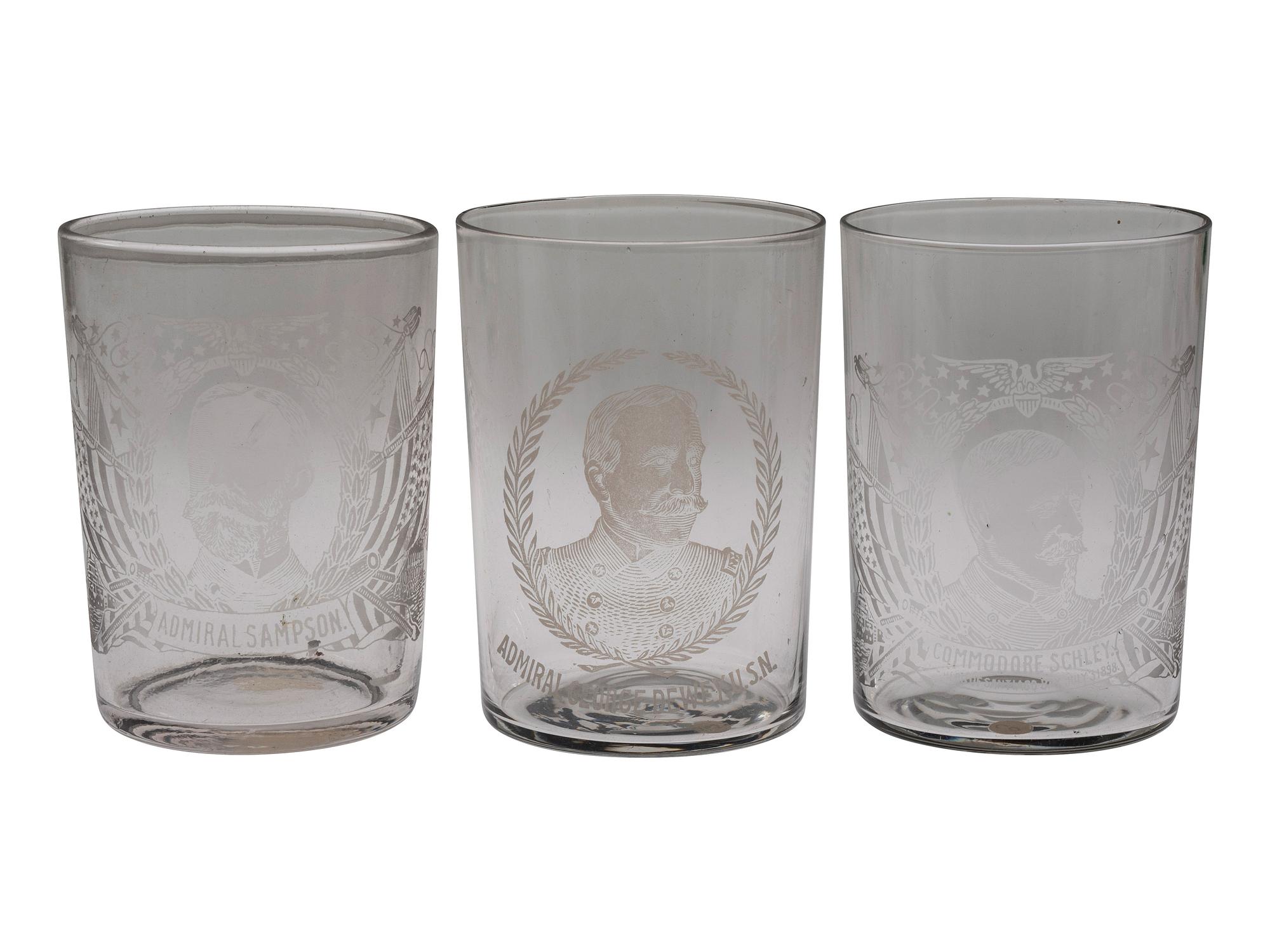[SPANISH-AMERICAN WAR]. A group of milk glass, paperweights, glasses, and other souvenirs including items commemorating the Maine and Admiral Dewey, including: