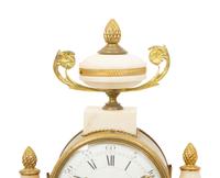 A French Gilt Bronze and Marble Mantel Clock with an Associated Pair of Urns