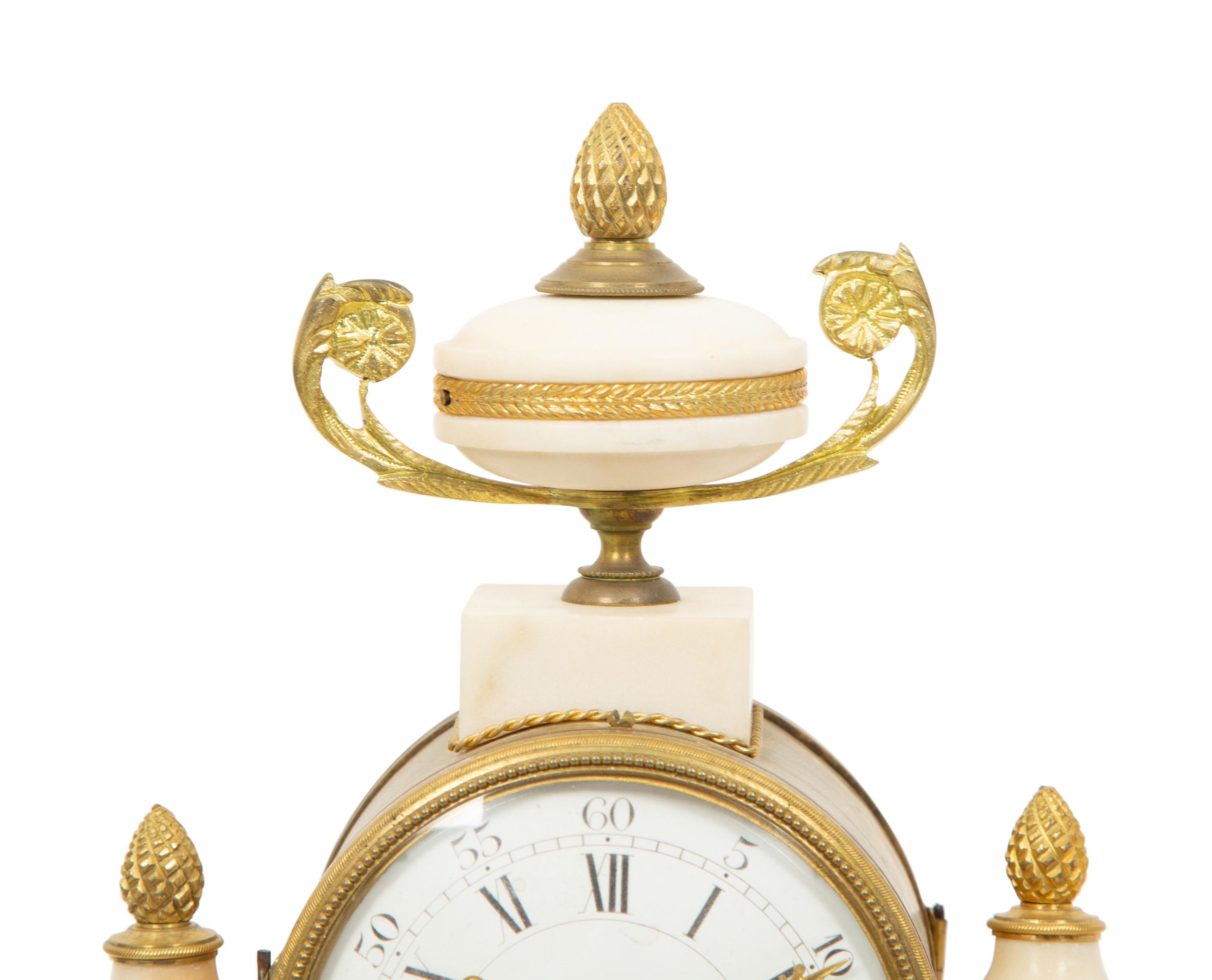 A French Gilt Bronze and Marble Mantel Clock with an Associated Pair of Urns