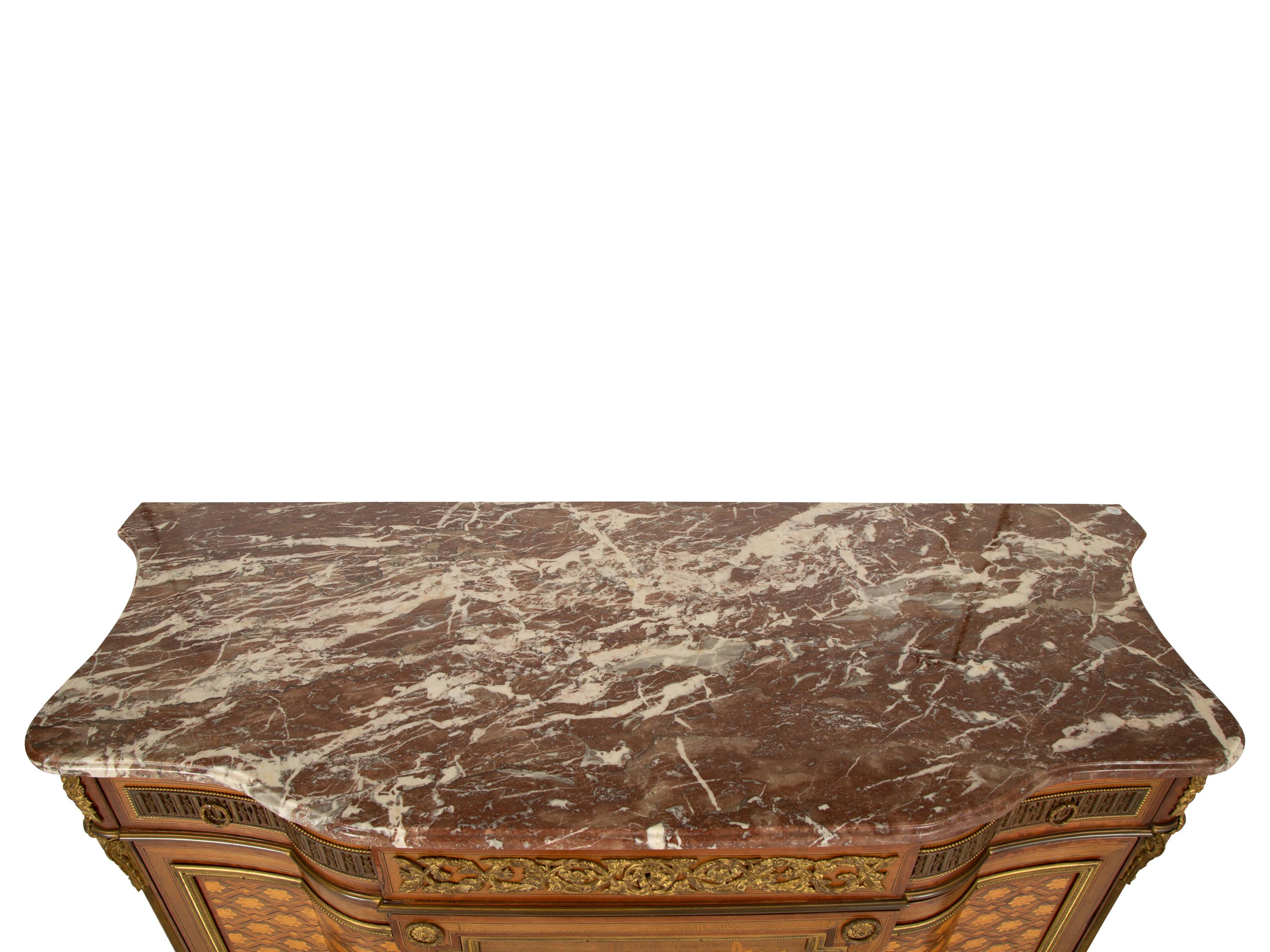 A Louis XVI Style Gilt Bronze Mounted Kingwood and Marquetry Marble-Top Commode