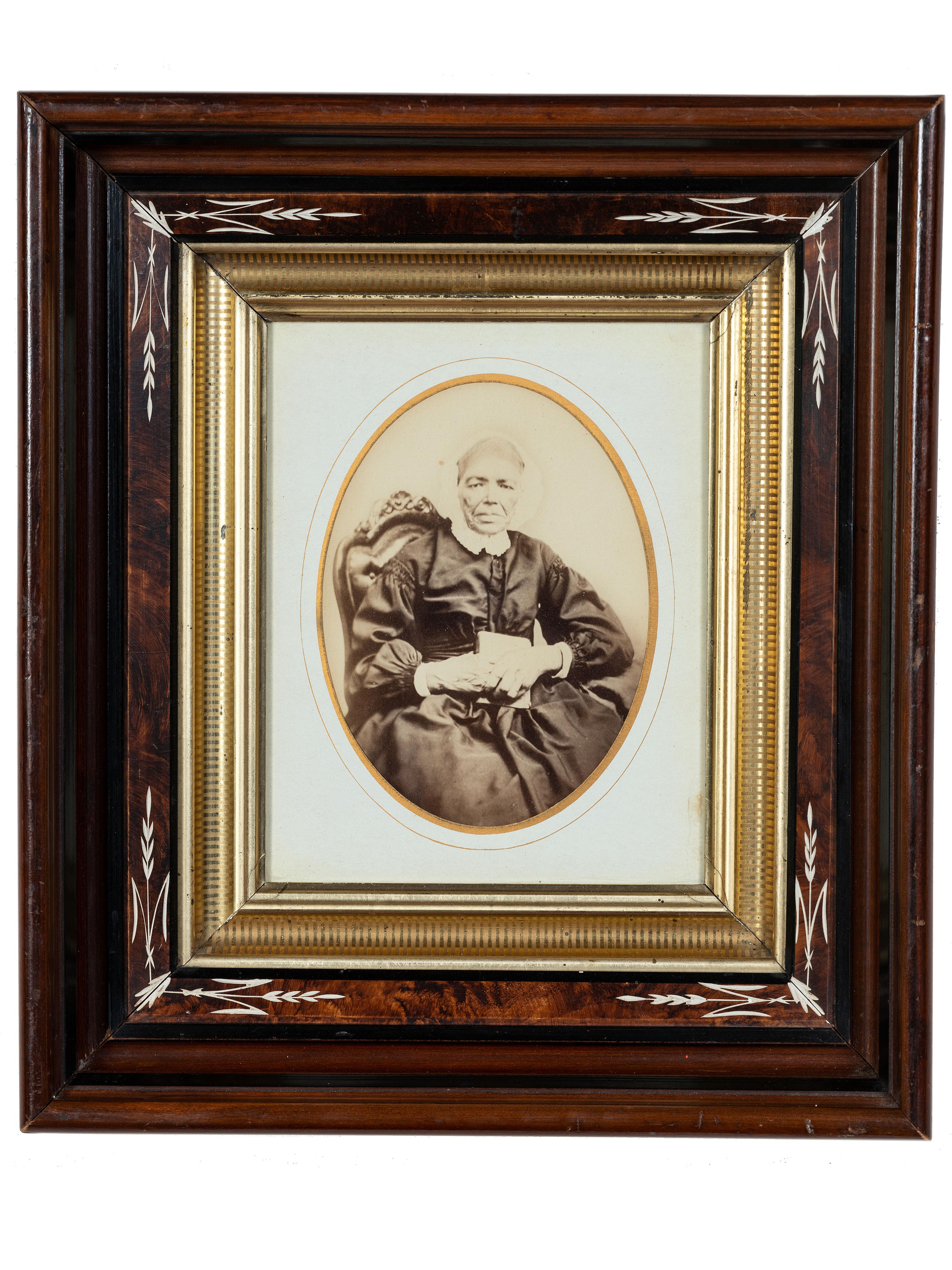 [EARLY PHOTOGRAPHY]. Albumen photograph of African American woman and tintype of white man found together in Louisiana. Ca mid 19th century.