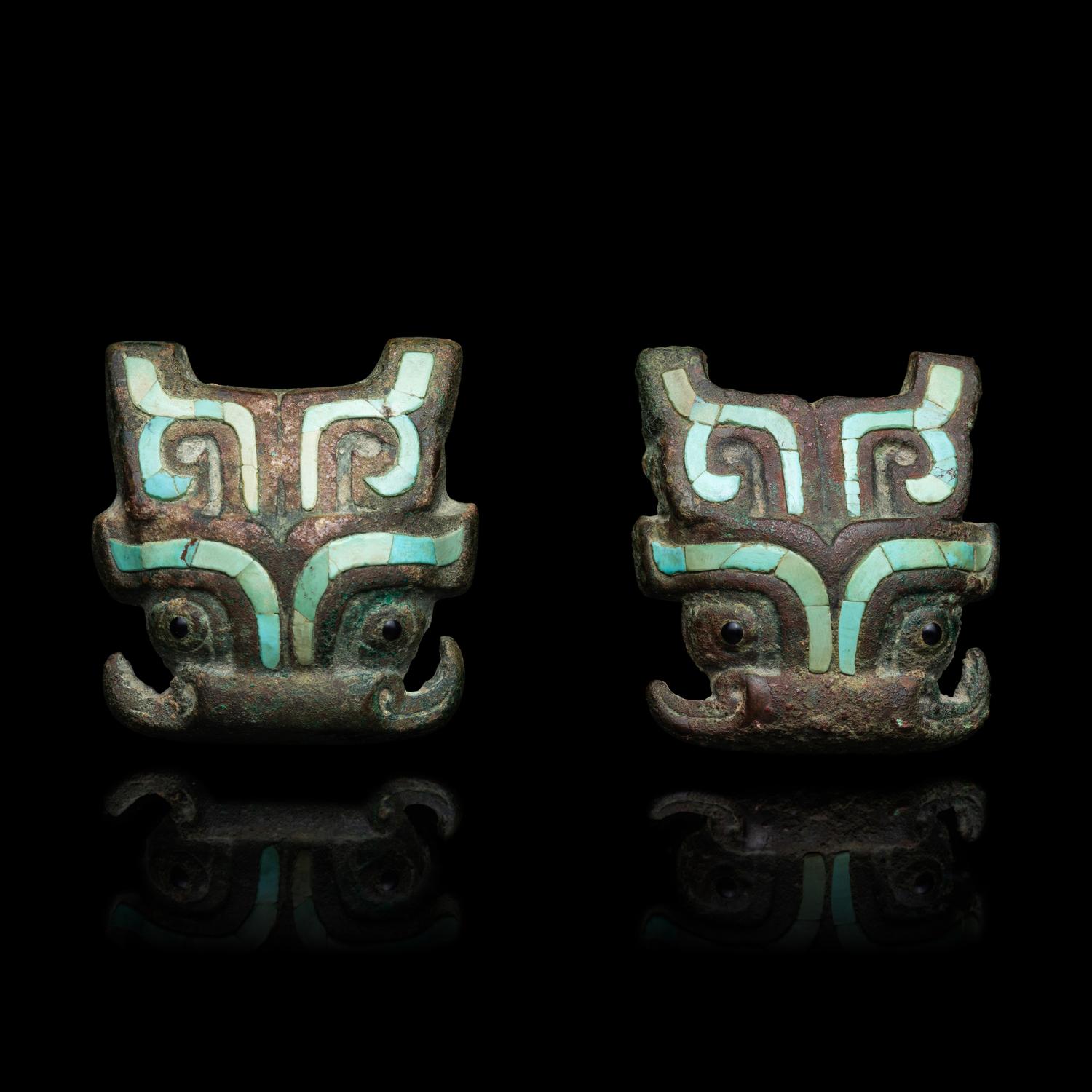 A Pair of Chinese Turquoise and Glass Inset Bronze Beast Mask Harness Ornaments, Late Western Zhou Dynasty-Warring States Period 西周晚期-戰國 青銅嵌松石饕餮紋马饰一對