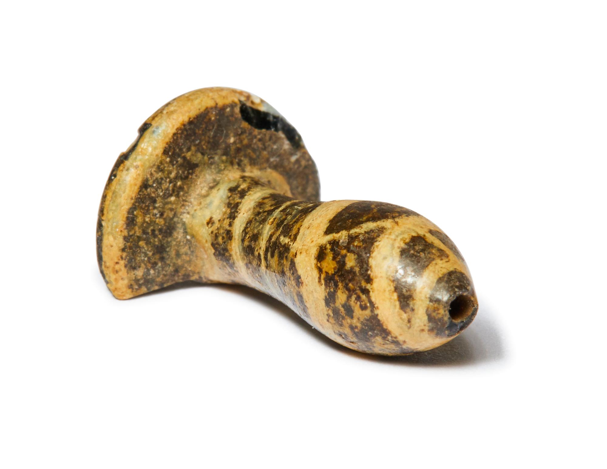 An Egyptian Charcoal and White Glass Ear Plug