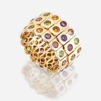An eighteen karat gold and gem-set bangle