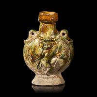 A Chinese Molded Sancai-Glazed Pottery Pilgrim Flask, Tang Dynasty 唐 三彩模印樂舞圖雙繫扁壺