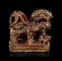 A Chinese Gilt and Red Painted Stone Fu Lion