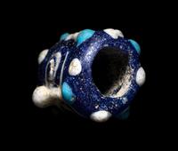 A Phoenician Glass Double-Face Bead