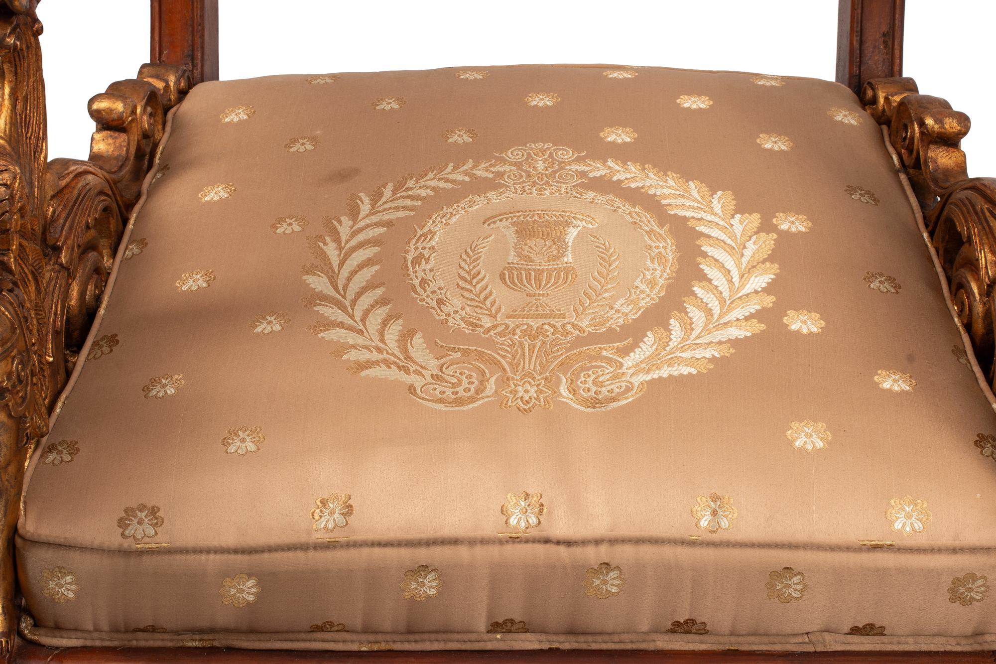 A Pair of Empire Style Parcel Gilt Walnut Armchairs