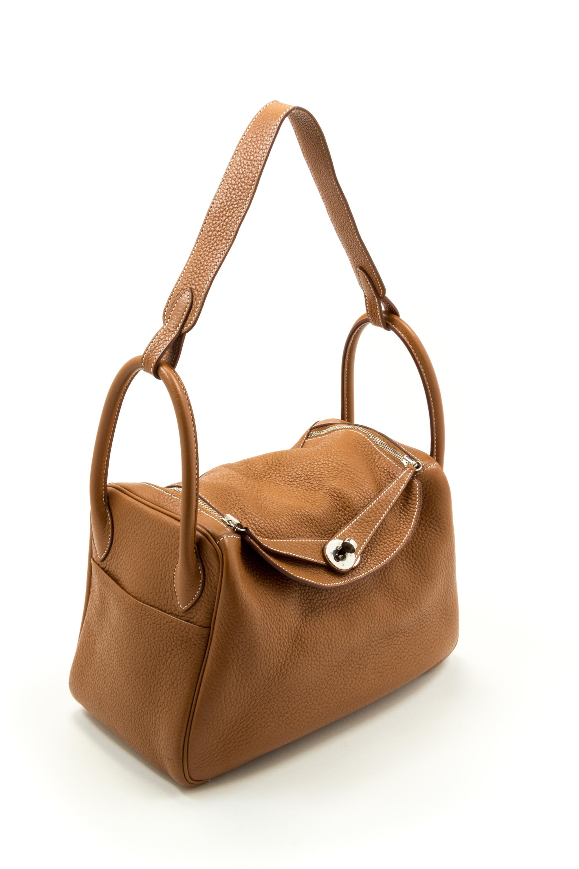 An Hermès Gold Clemence Lindy 30 Handbag, 12" x 7.5" x 6"; Strap drop: 12".